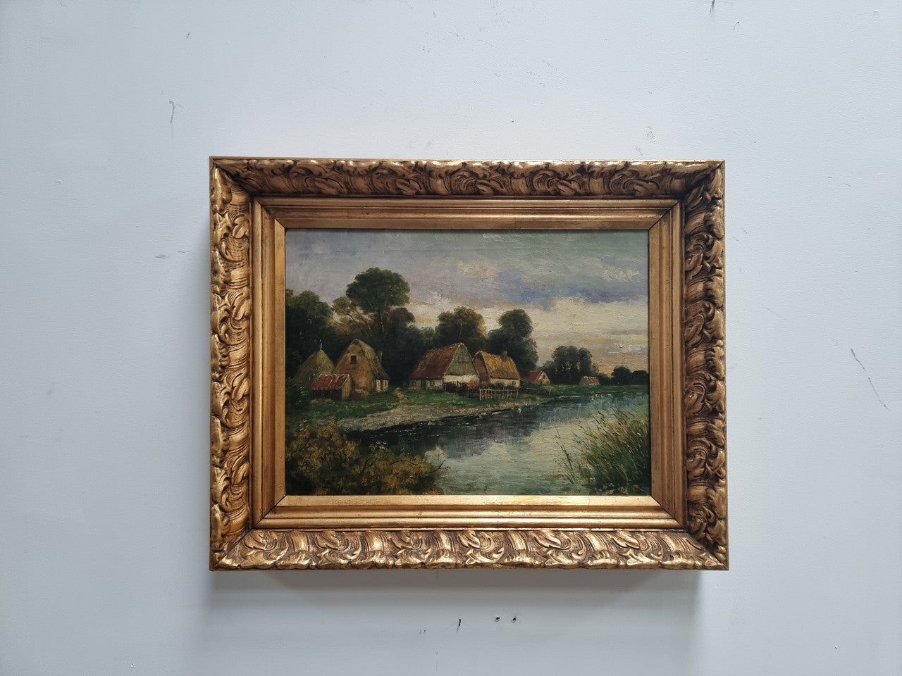 Lovely framed original oil on canvas of a country cottage scene on a river in good original condition