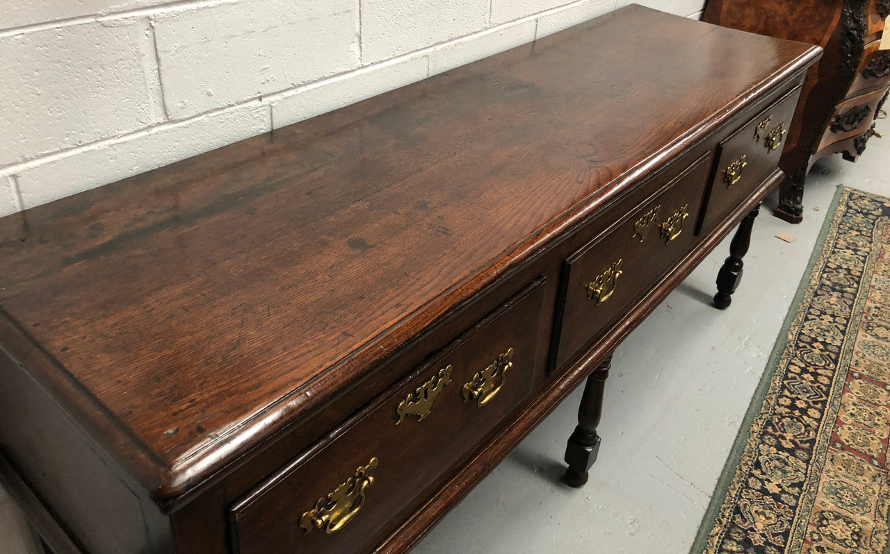 Early 19th Century English Oak dresser base with three large drawers. In very good original detailed condition.