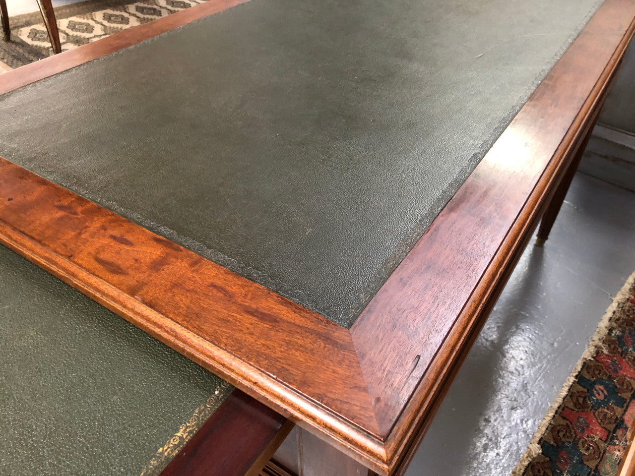Lovely French Mahogany Louis XVI style leather top desk. With beautiful ormolu details and three drawers. There are also two slides on either side with tooled leather tops and in good original detailed condition.