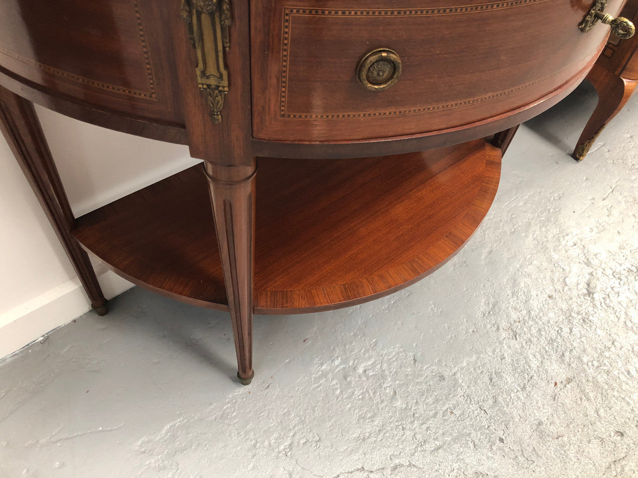 French marble top half round console table. It has beautiful marquetry inlay and ormolu mounts with a single drawer. In good original condition.