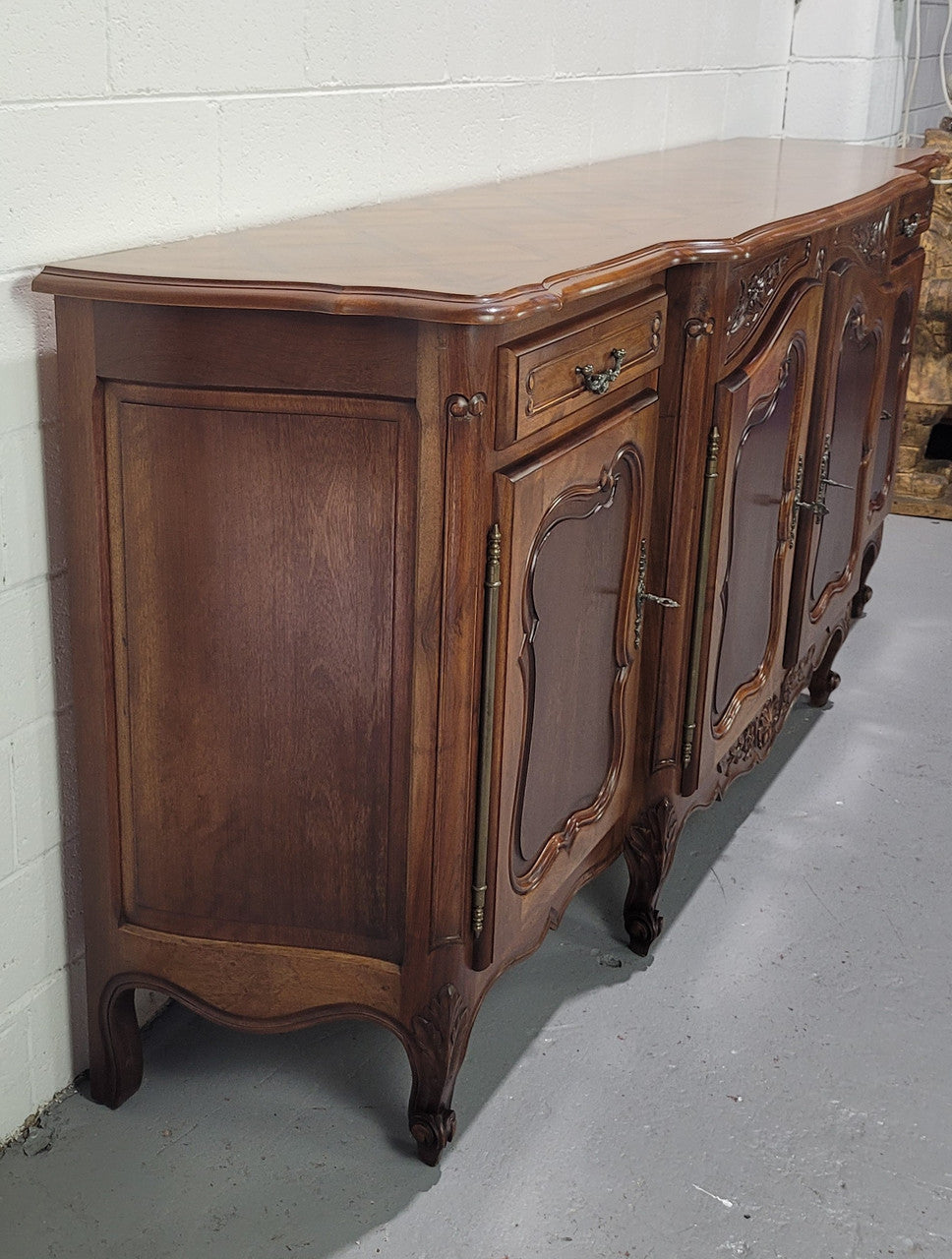 Walnut Louis XV style parquetry top four door sideboard with beautiful carving. Plenty of storage space and it is in good original detailed condition.
