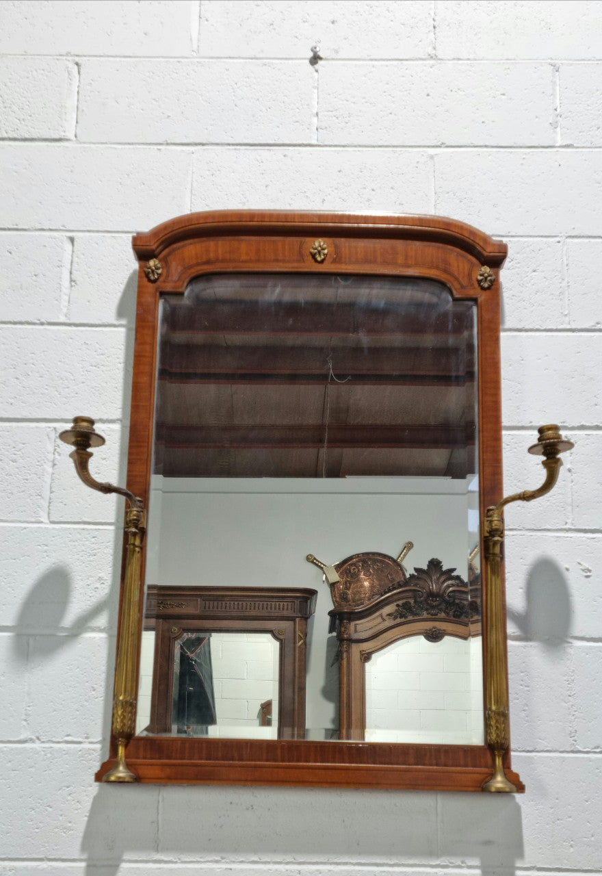 Decorative late 19th Century mahogany French wall mirror with brass swivel candle holders and brass detail. In good original detailed condition.