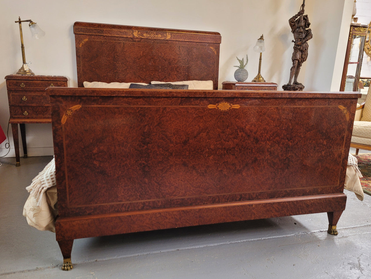 French Art Deco bedroom suite consisting of queen size bed in Amboyna wood and featuring pretty inlay. It comes with a matching pair of bedsides. It is a very stylish and high quality suite. It has been sourced from France and is in good original detailed condition.