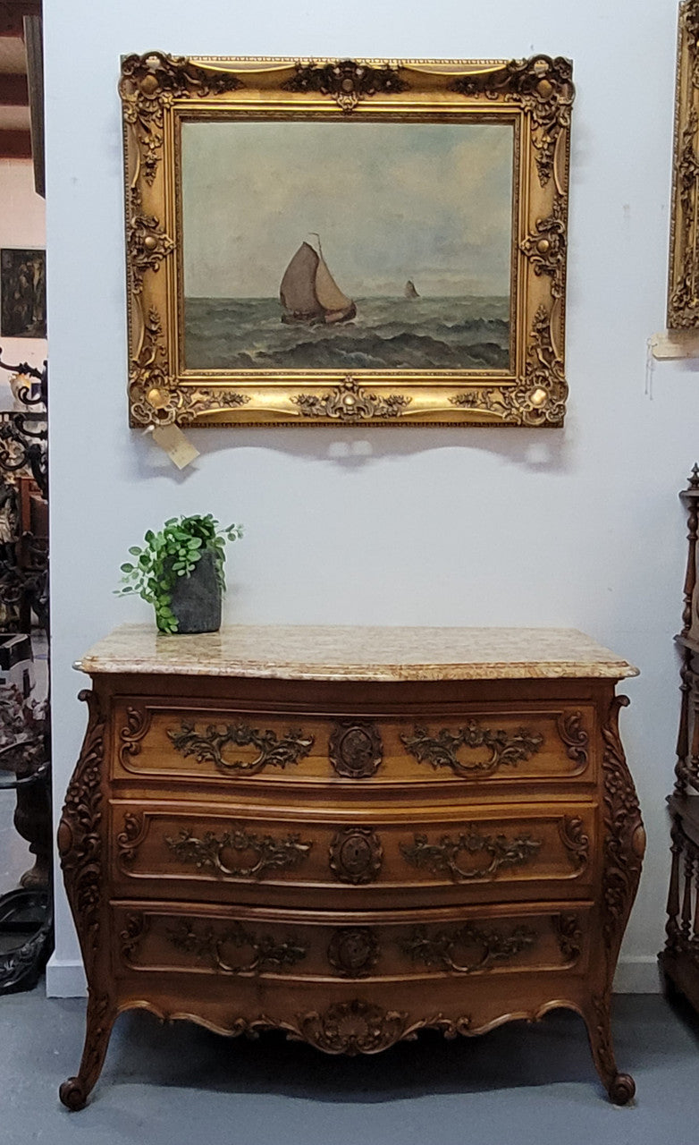 Impressive Louis XV style three drawer walnut commode. Ormolu handles and bevelled marble top complimenting detailed carving. In very good original detailed condition.