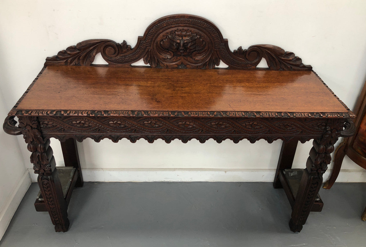 Superb 19th Century Gothic style hall/console table. It has umbrella and walking stick holders on both sides. In good original detailed condition.
