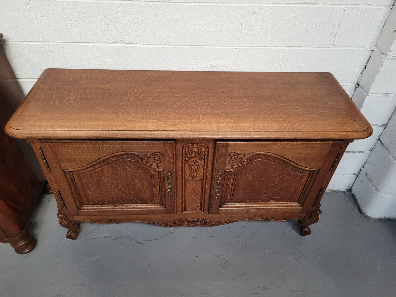 French Oak Louis XV Style two door nicely carved cabinet which would make an ideal TV cabinet. There are two doors for all your storage needs and is a very solid piece. In good original detailed condition.