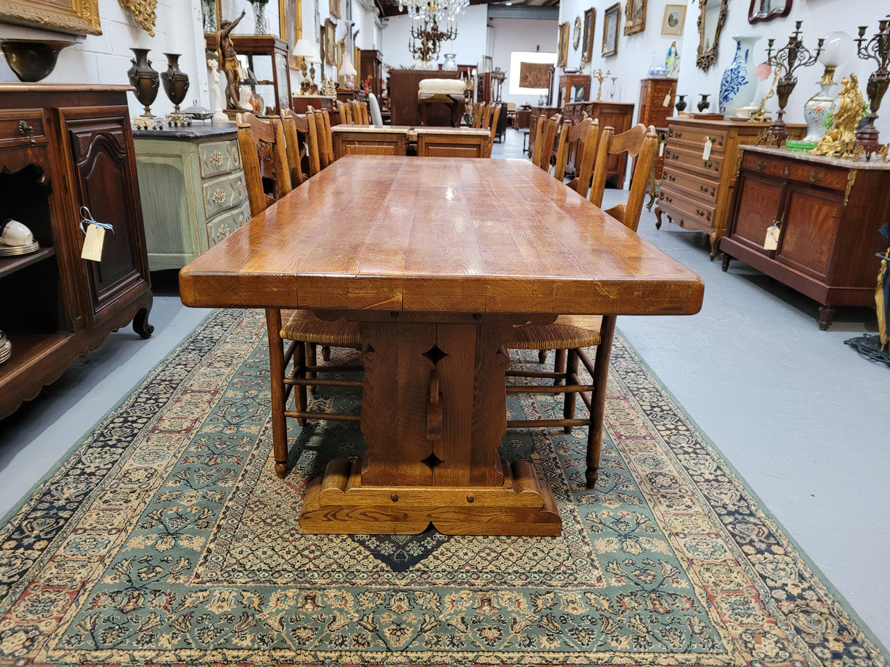 French Farmhouse table with a beautiful thick plank top and stretcher base. Can seat 8-10 people comfortably and is in good original detailed condition.