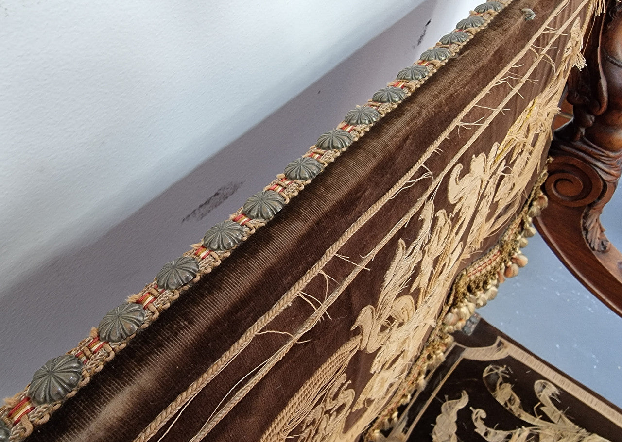 Beautifully carved Walnut Egyptian Revival armchair with amazing hand sewn Stumpwork embroidery coverings. In good original detailed condition.