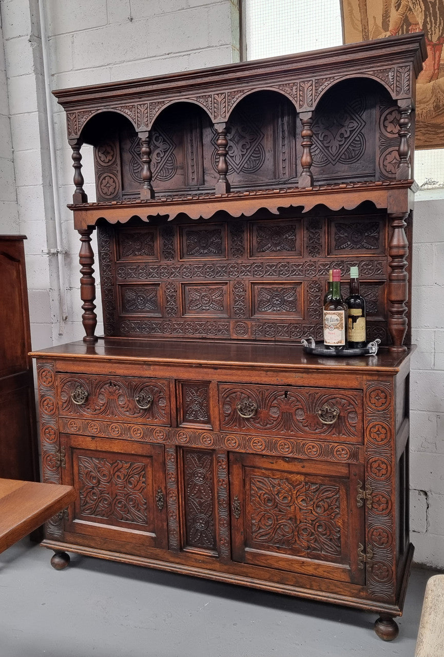 Impressively carved 18th Century English Oak kitchen dresser in 17th Century Jacobean style. It is in good original detailed condition and has been sourced from France.