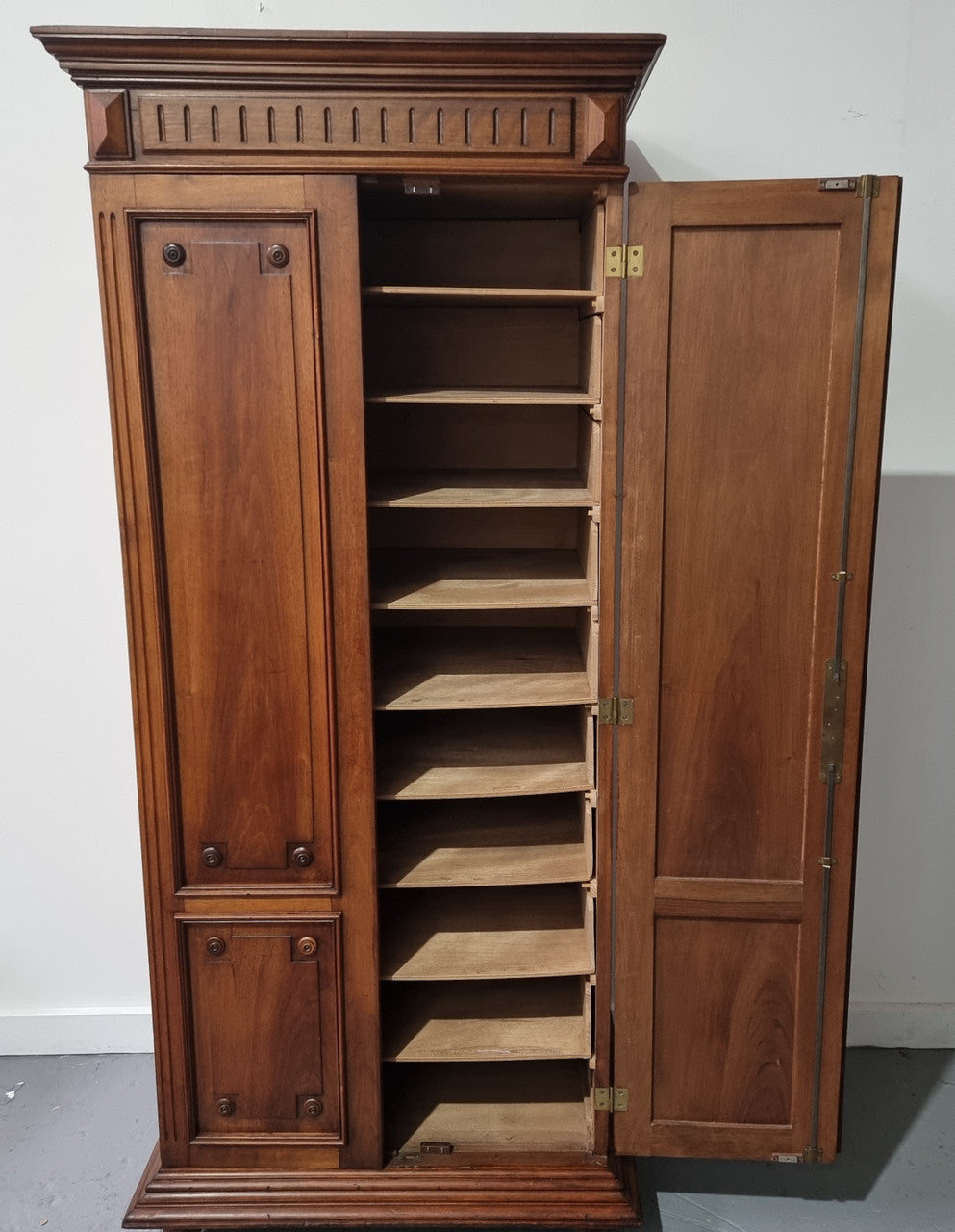 French Henry II style Walnut linen storage cupboard with nine pull out shelves. This piece could be very functional for a range of different purposes including shoe storage. It is in good original detailed condition, please note the door lock no longer functions and opens by pulling the door.
