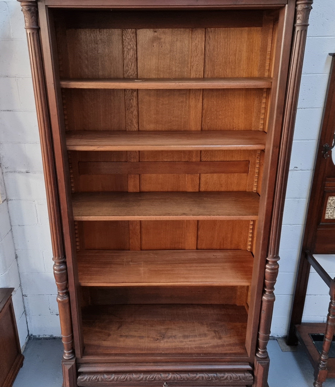Henry II style 19th century walnut open bookcase with drawer which was originally an armoire now converted to a bookcase. It comes with four adjustable shelves. Is in good detailed condition.