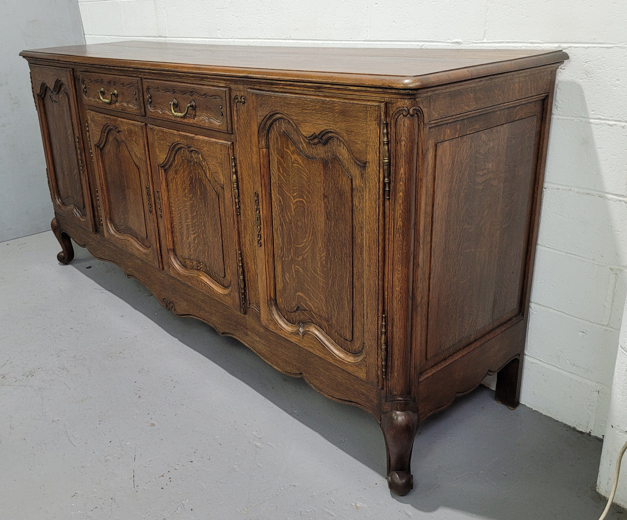 Late 19th Century French carved Oak Louis XV style four drawer sideboard. Plenty of storage space with four cupboards and two drawers. It is in good original detailed condition with all locks functioning with keys.