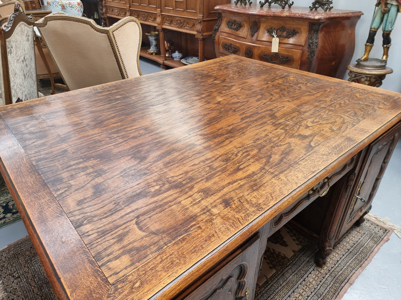 Fabulous Louis XV style French Oak beautifully carved full partners desk. Both sides have a functioning drawer in the middle and two cupboards either side. On both sides one cupboard door opens up to four smaller internal drawers. Plenty of storage space and a large top surface to work on. It is in good original detailed condition.