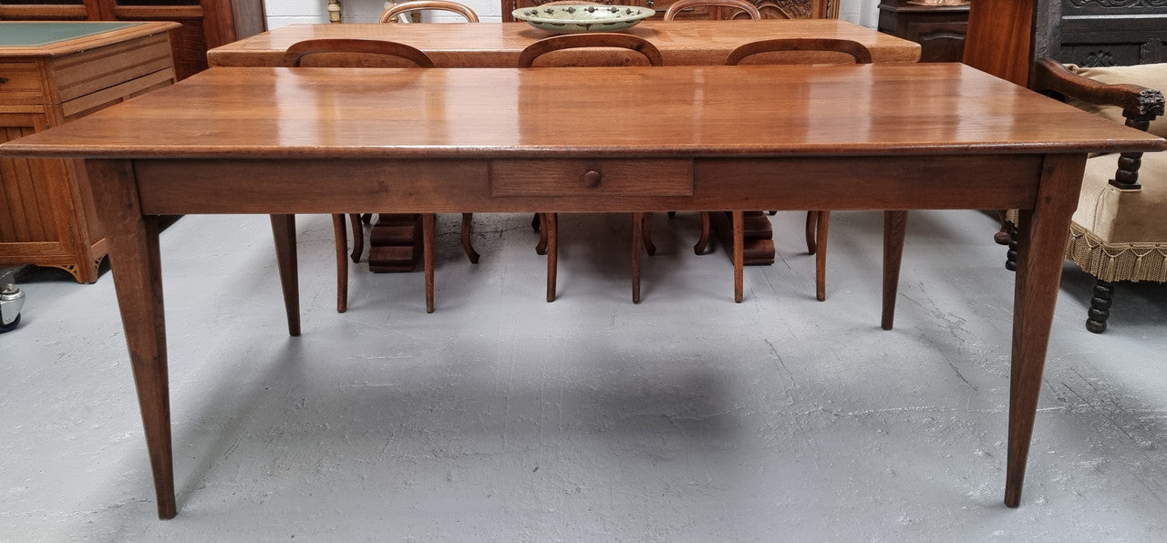 Antique French Oak Farmhouse table in fully restored condition. Features a single drawer and tapered legs.