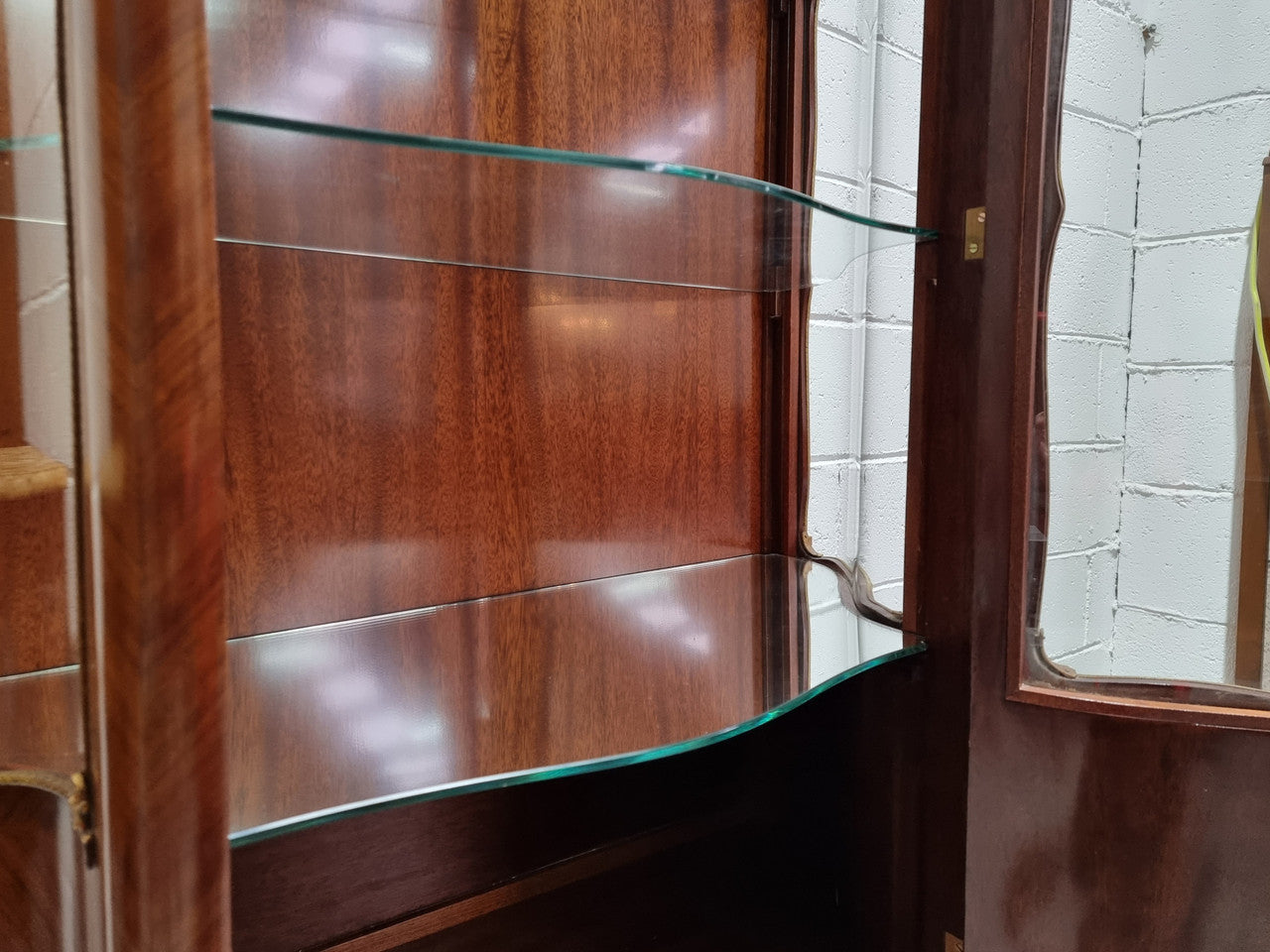 Grand French Walnut Louis XV style marble top vitrine. It has two glass shelfs and one mirrored shelf at the bottom and added storage at bottom. It is in good original detailed condition.