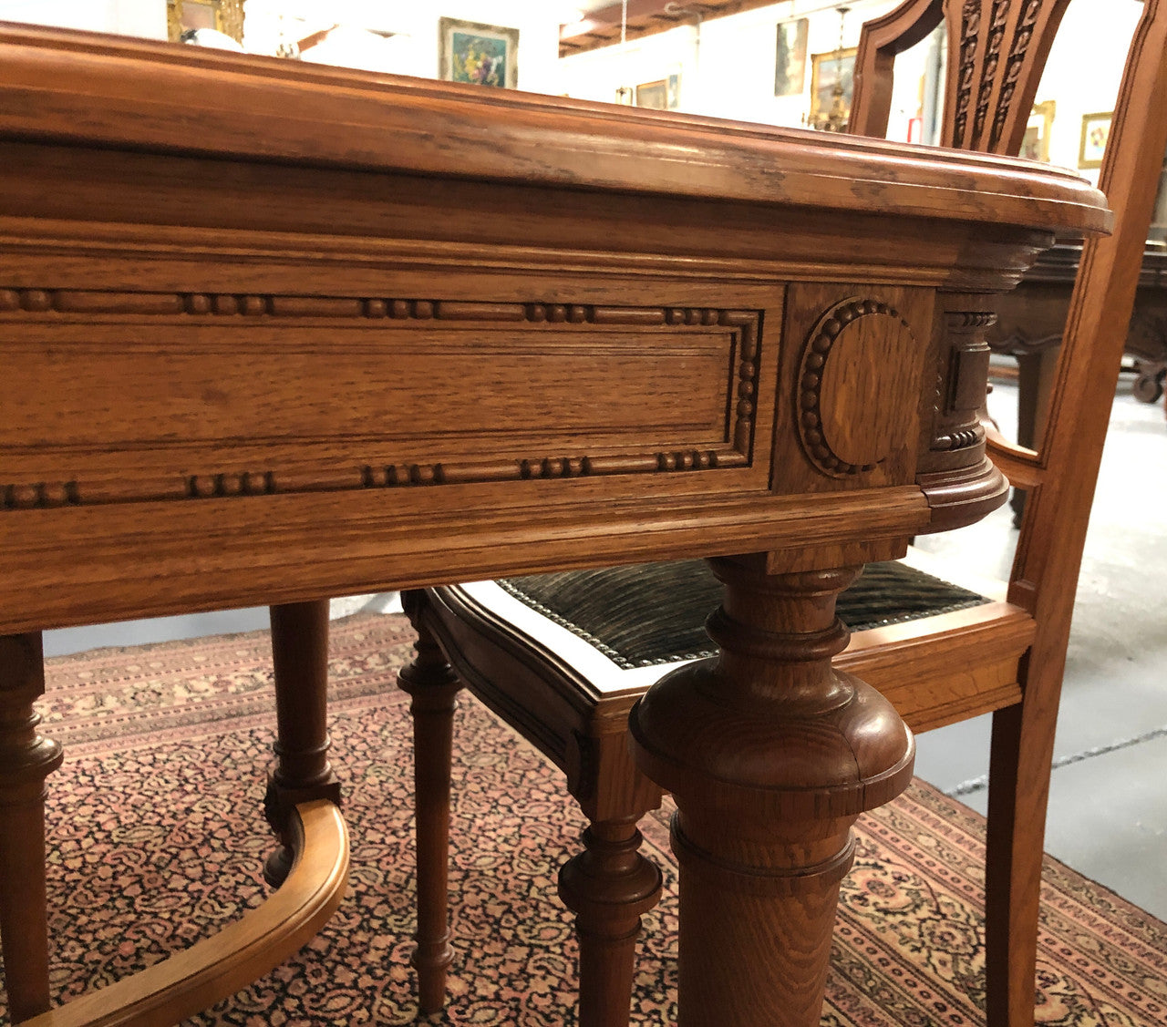 Lovely carved French Oak dining table with a parquetry top and six matching upholstered chairs in good original detailed condition.