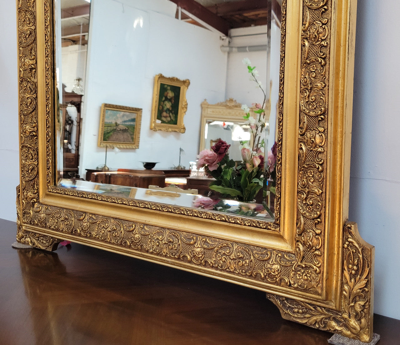 French 19th Century gilt over mantle mirror with beveled glass. In good original detailed condition.
