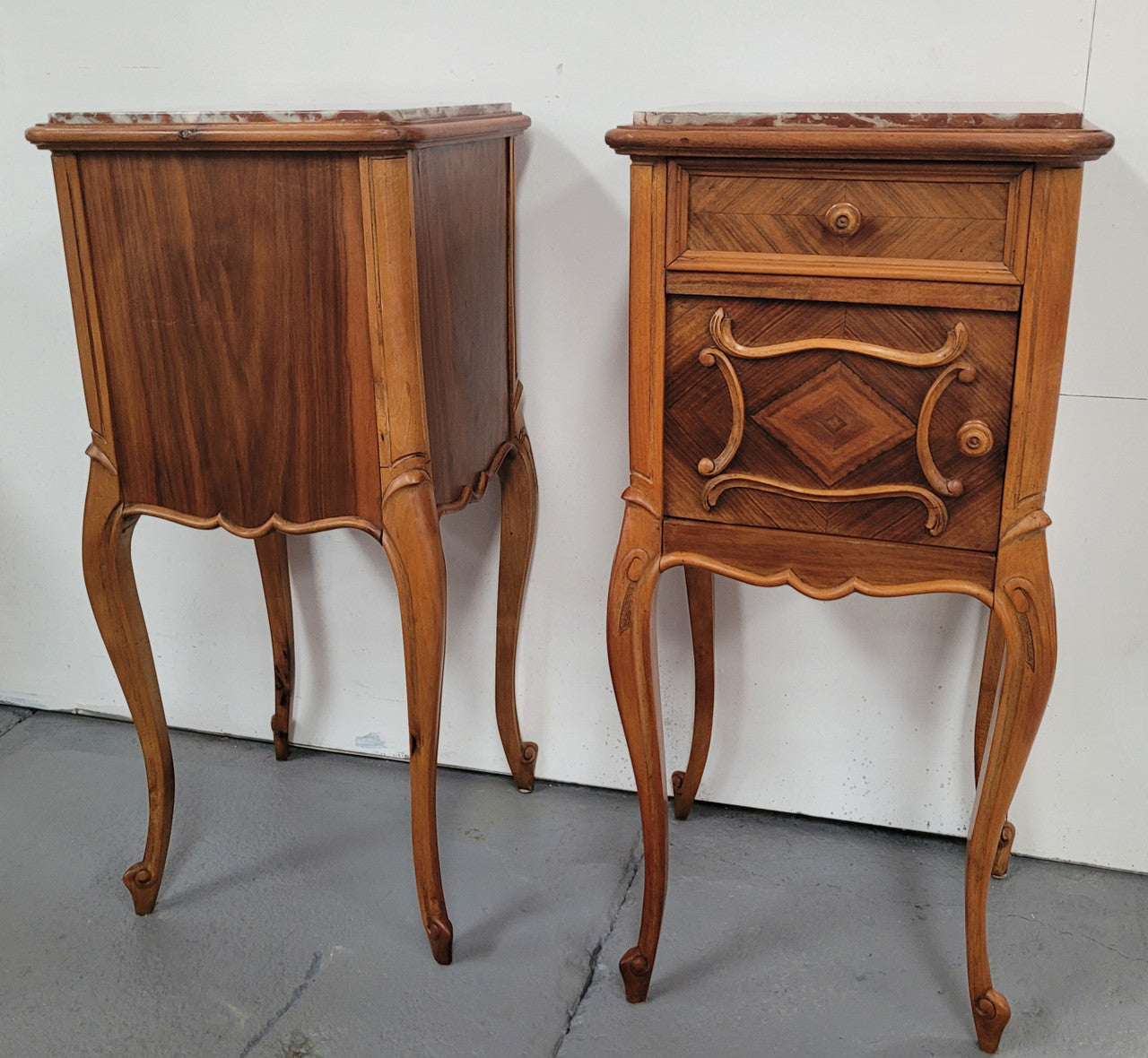Pair French Walnut Louis XV style Bedside Cabinets with inset rouge carrera marble tops and parquetry inlay. Consisting of one drawer and one cupboard on very elegant legs. Circa: 1900's.