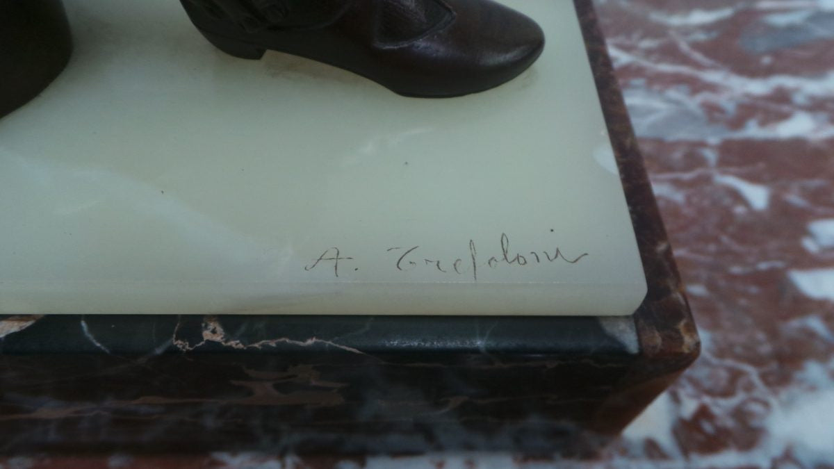 An Art Deco bronze statue with brown patina, of a lady and parrot on a marble base. Signed by Italian Sculptor A Trefoloni, an important and highly regarded sculptor. The statue is in very good condition.
