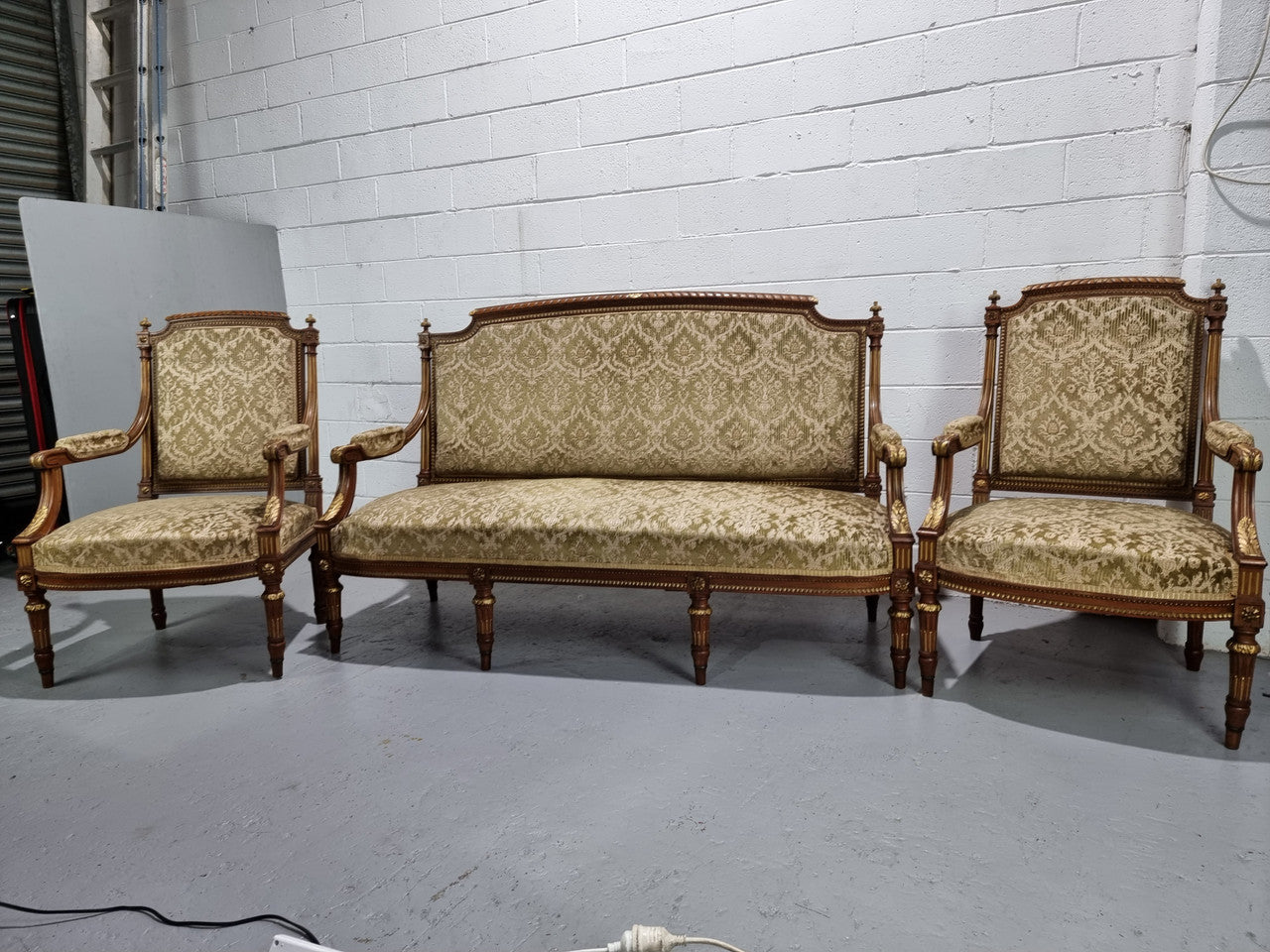 Beautiful French walnut Louis XVI style upholstered three piece Salon Suite. It has lovely fabric which is in overall good condition and is very comfortable to sit in. In good original detailed condition.