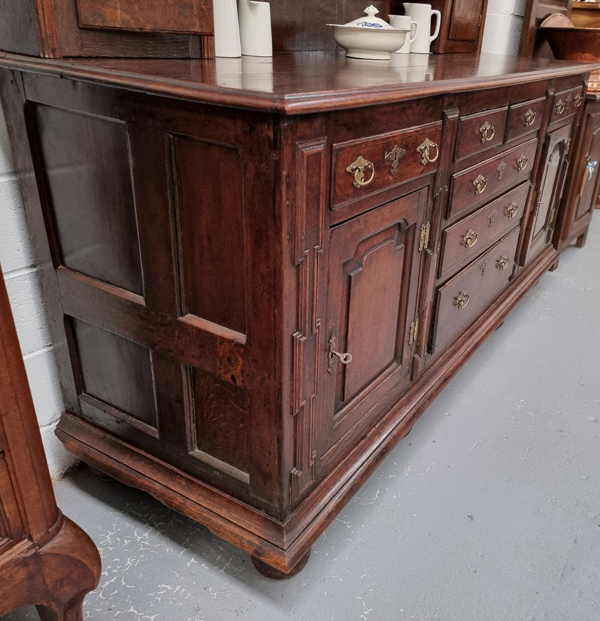 18th Century English Oak Farmhouse dresser of grand proportions. It was sourced in France and not only looks amazing but also has plenty of practical storage space. It is in good original detailed condition.