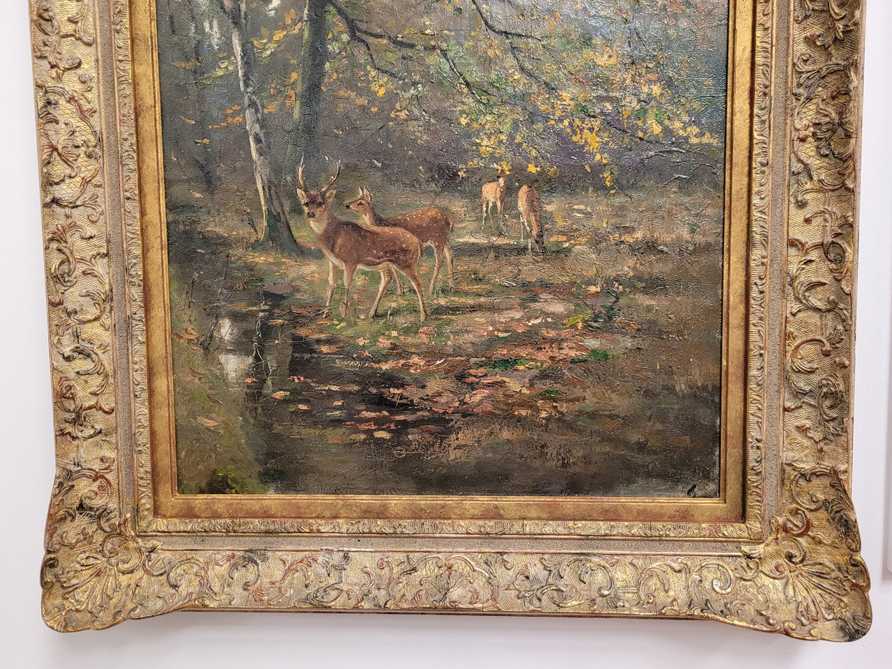 Charming oil painting on canvas depicting a forest scene and deer in an ornate gilt frame. In good original detailed condition.