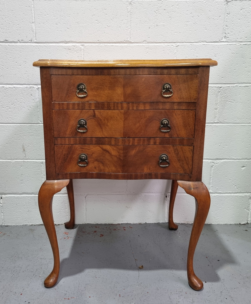 Antique Queen Anne style figured Walnut Bedside cabinet with 3 drawers. It is in good original detailed condition.