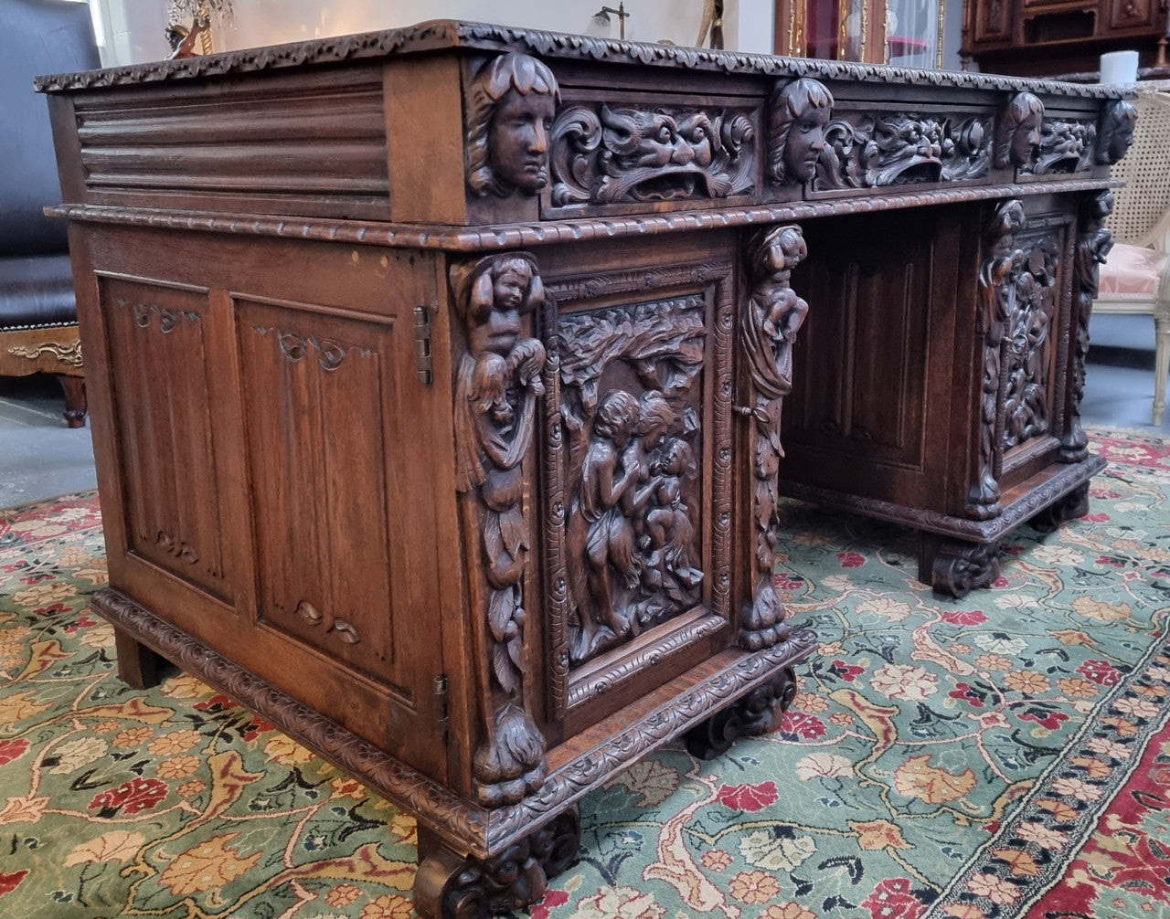Beautifully carved French Oak early 19th century pedestal desk with 3 drawers, two cupboards and a secret cupboard on the side. There is also a lovely burgundy tooled leather top. In good original detailed condition.