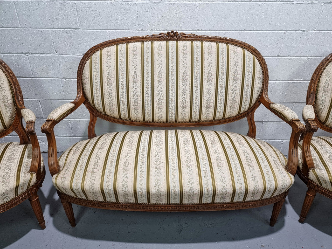 French carved Walnut Louis XV style settee and two matching armchairs. They are in good condition with upholstery also in good condition.