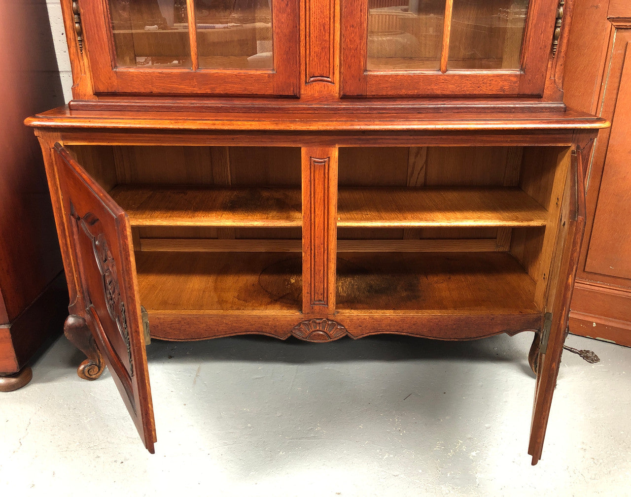 Vintage French Oak two door bookcase/display cabinet with a two door storage cabinet at the bottom. It is in good original condition.