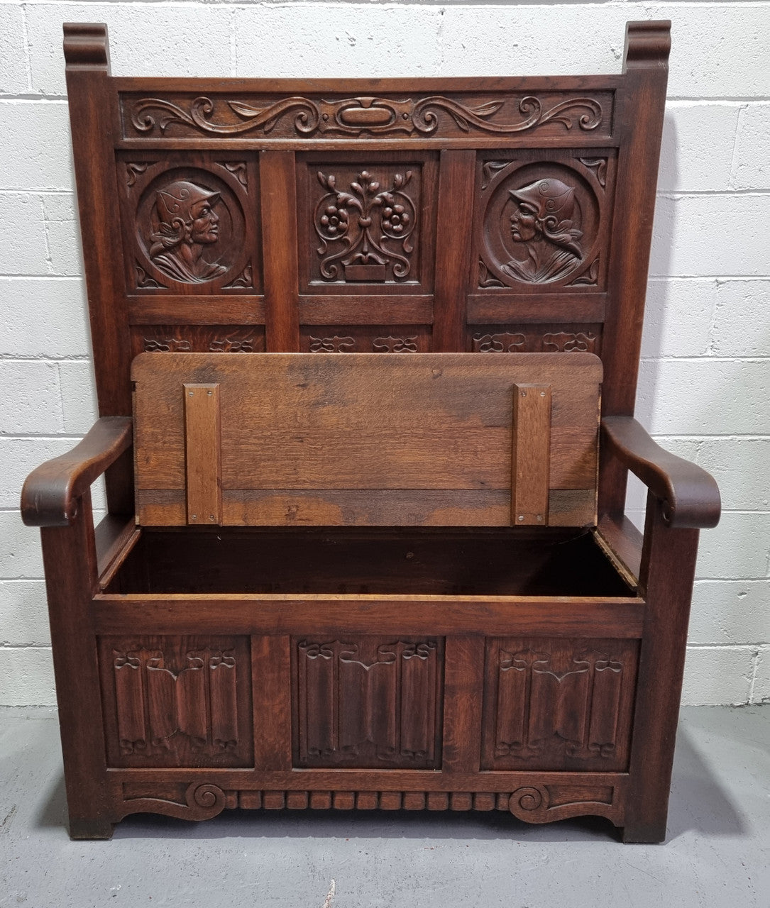 Decorative and nicely carved French Oak 19th Century hall seat with lift up lid for storage. Beautiful details and in good original detailed condition.