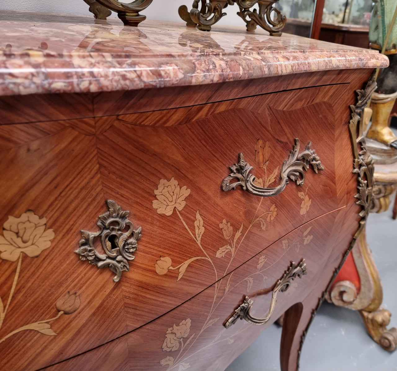 Stunning Louis XV style marquetry inlay marble top two drawer commode. It has decorative ormolu mounts and beautiful marble top. In good original detailed condition.