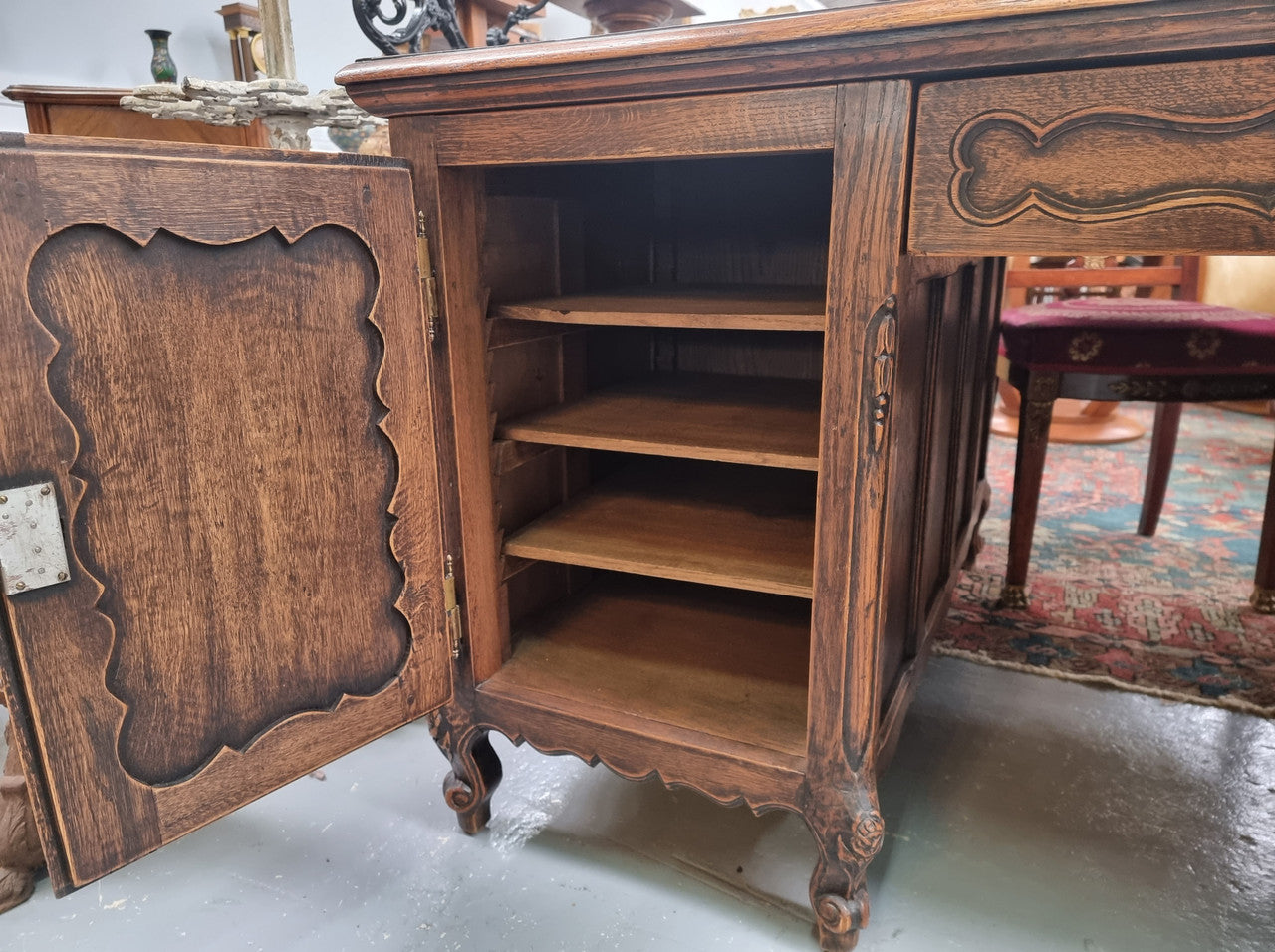 Fabulous Louis XV style French Oak beautifully carved full partners desk with an amazing tooled leather top. Both sides have a functioning drawer in the middle and two cupboards either side. On both sides one cupboard door opens up to four smaller internal drawers. Plenty of storage space and a large top surface to work on. It is in good original detailed condition.