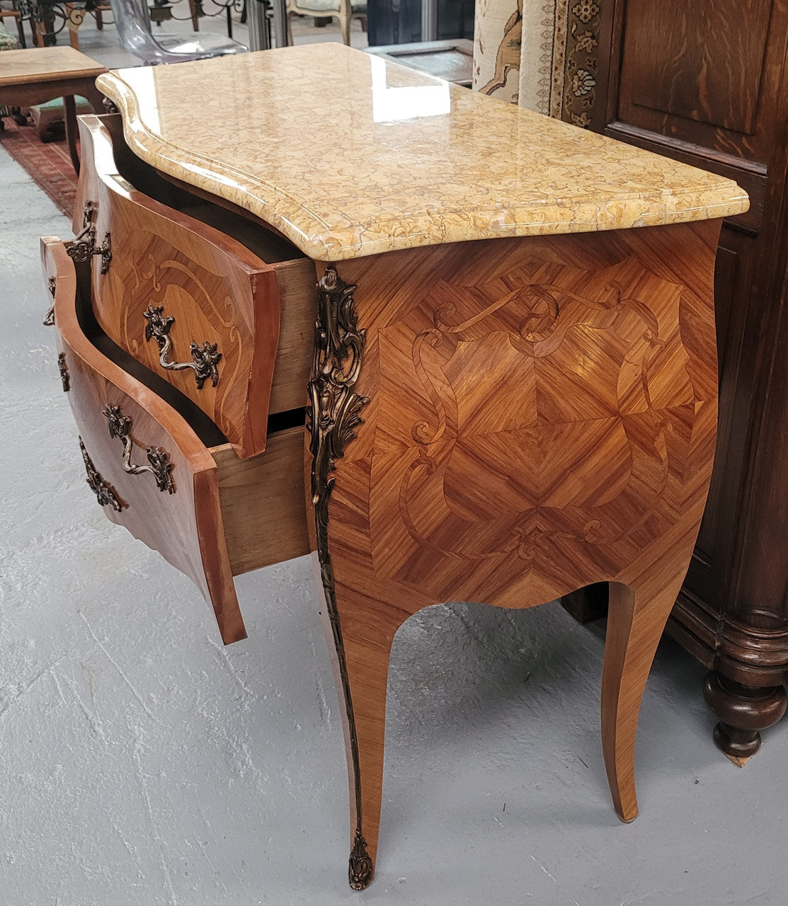 An elegant French Louis XV style kingwood two drawer commode with beautiful decorative inlay and ormolu mounts. Stunning coloured marble top and is in good original detailed condition.