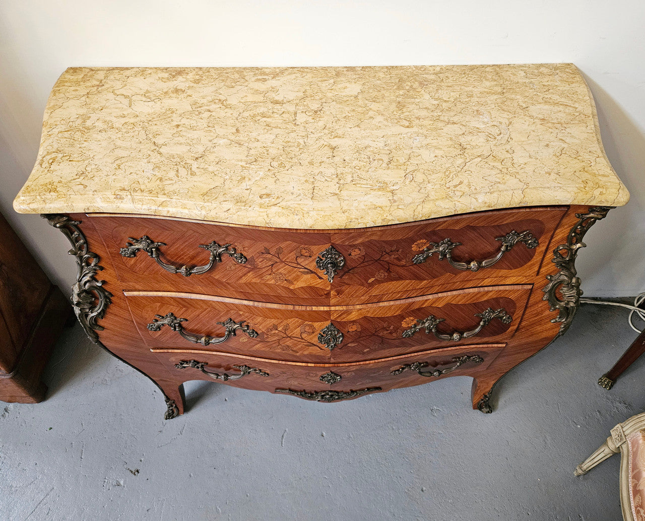 Stunning French Louis 15th style marble topped three drawer commode with marquetry inlay and stunning ormolu mounts. In good original detailed condition.
