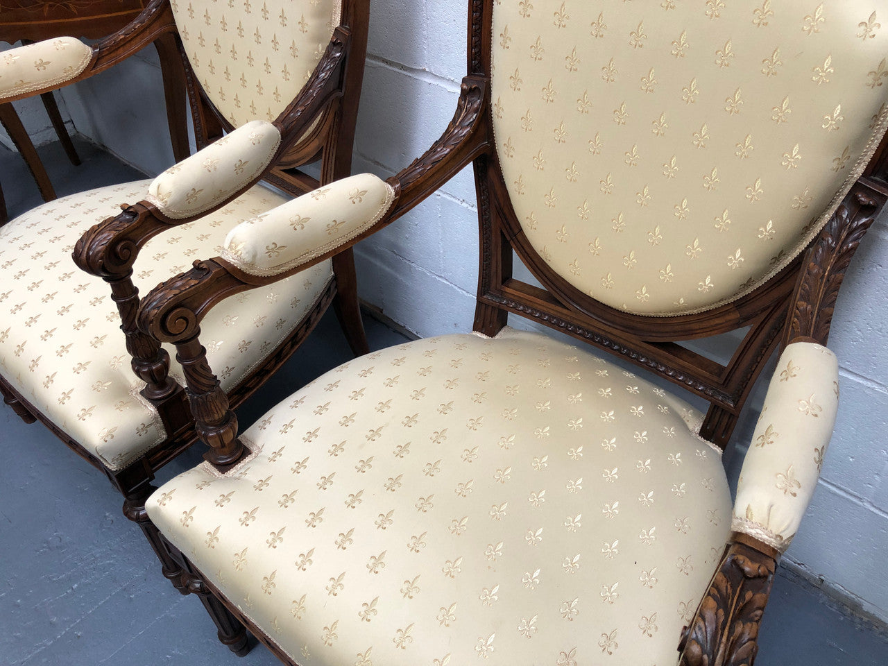 Beautiful pair of Vintage French Walnut Louis XVI style carved Fauteuils with lovely upholstery and wide seats . In good original detailed condition.