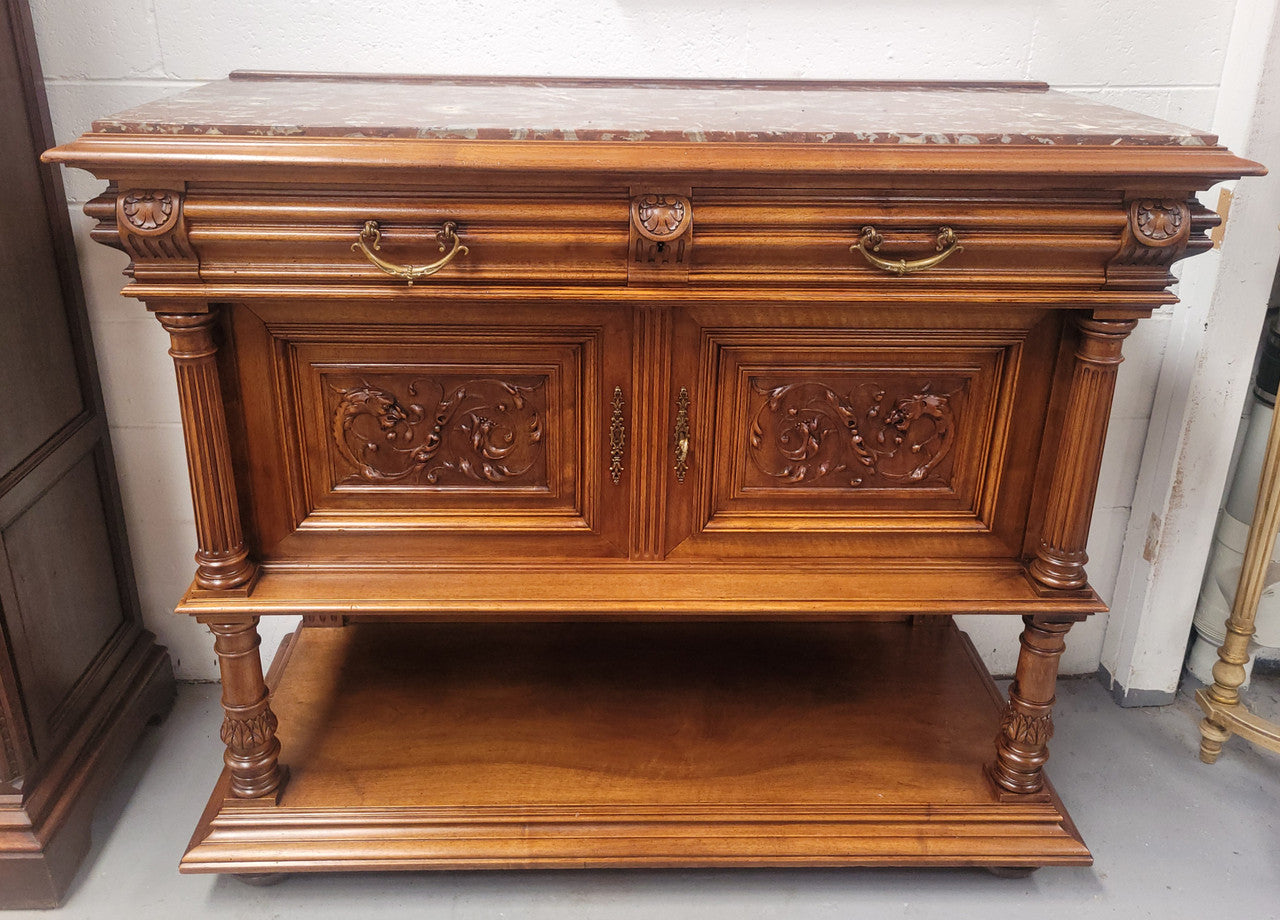 Stunning Henry II style French Walnut marble top buffet. It has a beautiful marble top and plenty of storage with two drawers, two doors with beautiful decorative carvings and an open shelf. It has been sourced from France and is in good original condition and has been detailed to a high standard.