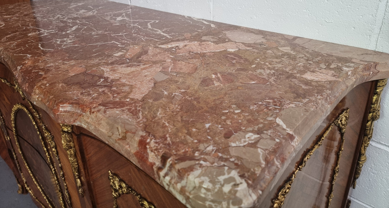 Stunning Louis XV style ormolu and marquetry marble top commode with two drawers. It has an amazing thick marble top and it is in good original detailed condition.
