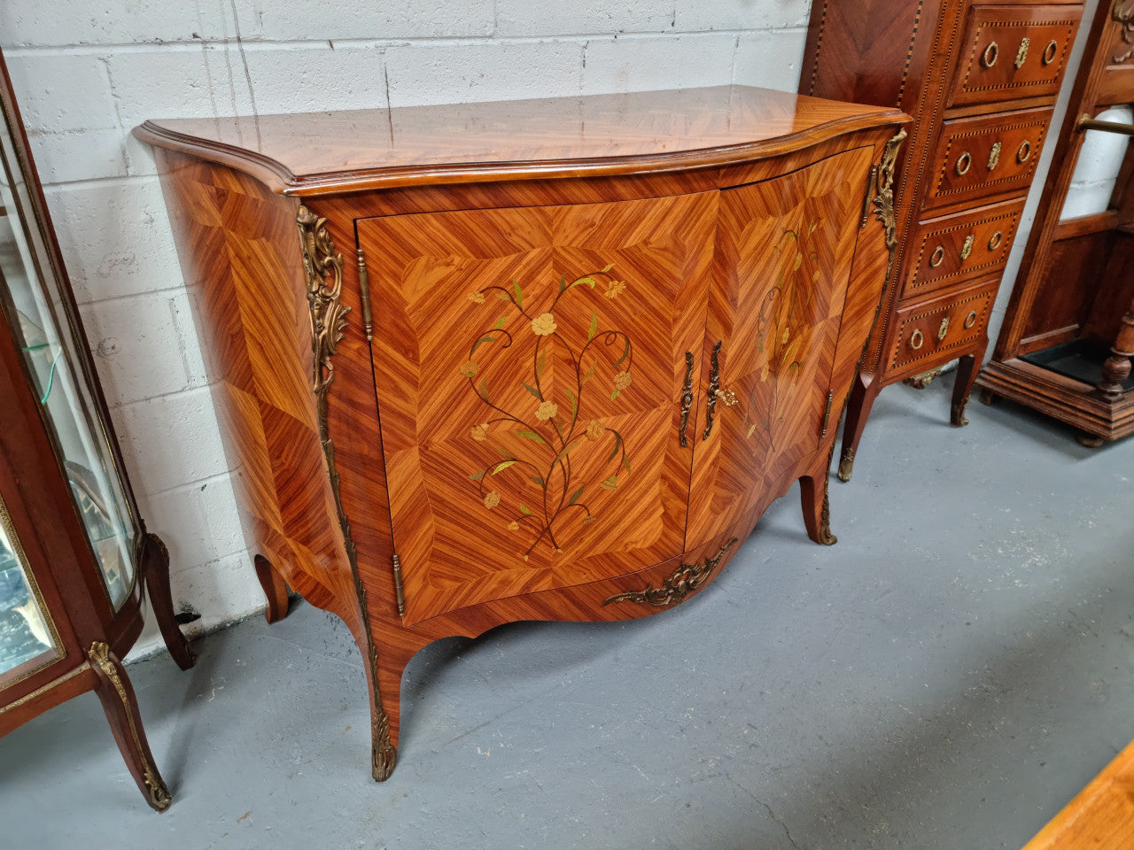 A high quality Louis XV style Kingwood marquetry inlay cabinet. Features extensive inlay inside the doors, and has beautiful ormolu mounts. In good original detailed condition.