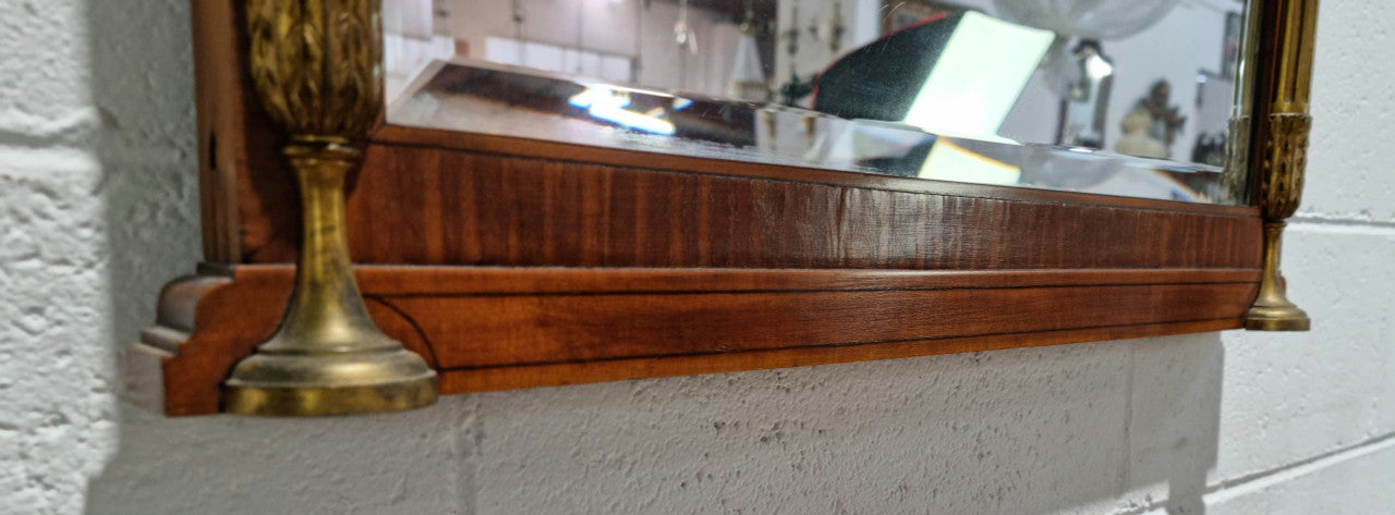 Decorative late 19th Century mahogany French wall mirror with brass swivel candle holders and brass detail. In good original detailed condition.