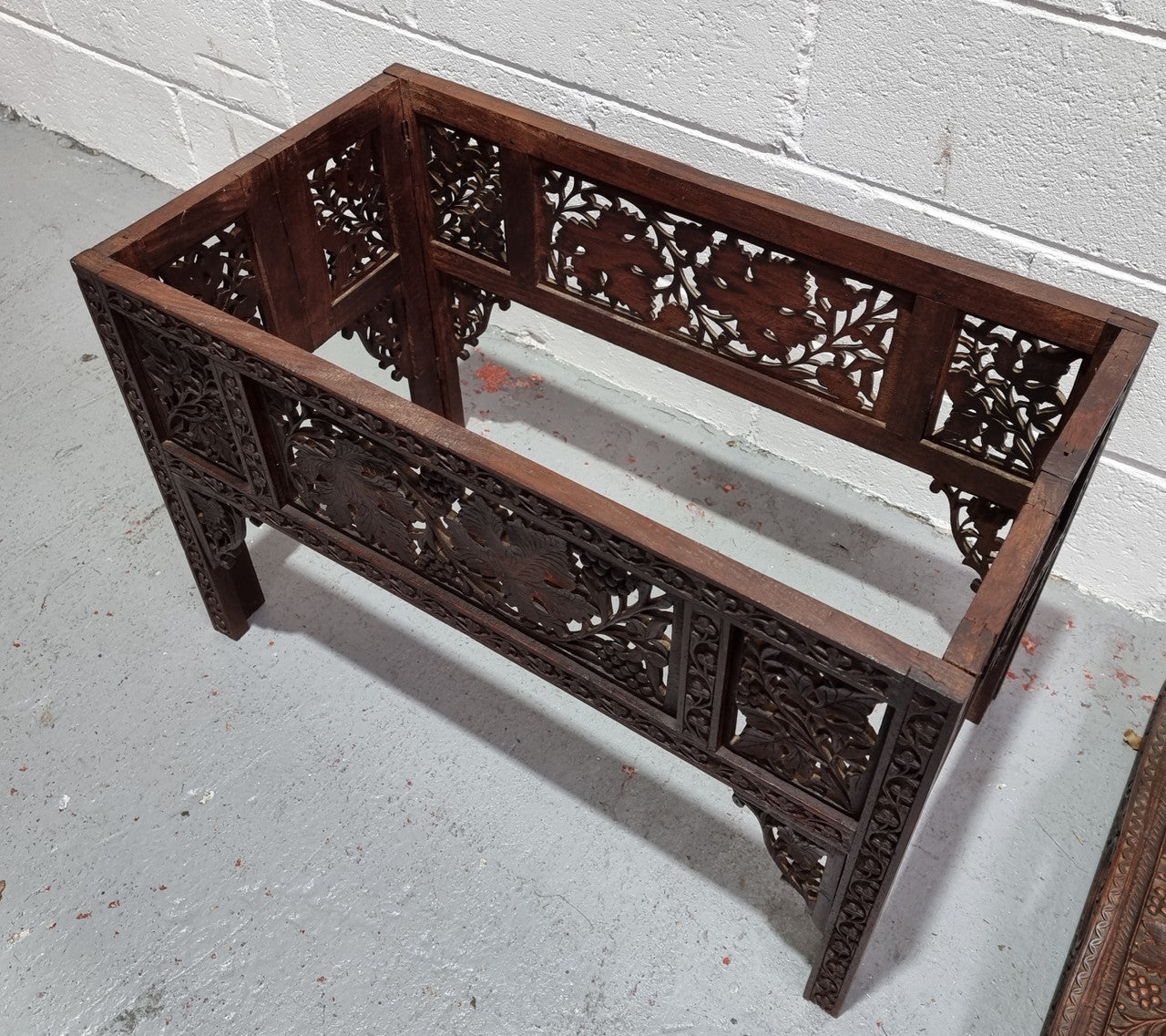 Anglo Indian folding occasional table with lift-up tray top. The tray has brass inlay and ornate carvings. The bottom of the table folds down and it is in good original condition.