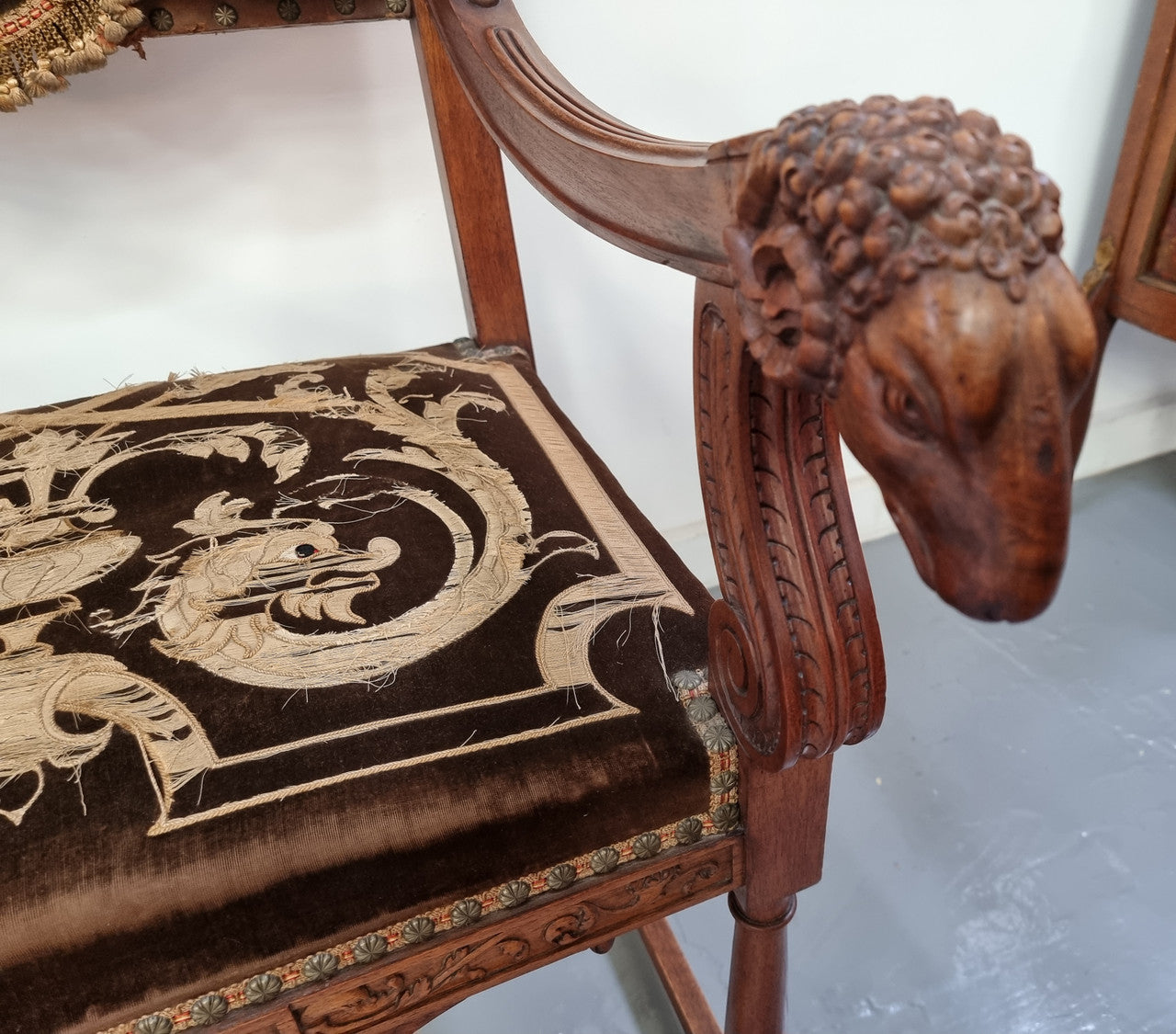Beautifully carved Walnut Egyptian Revival armchair with amazing hand sewn Stumpwork embroidery coverings. In good original detailed condition.