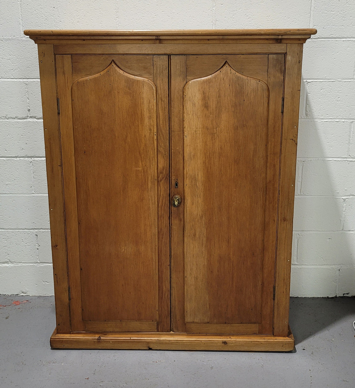 A lovely Victorian Pine shield cupboard with two doors and four shelves in good original detailed condition.