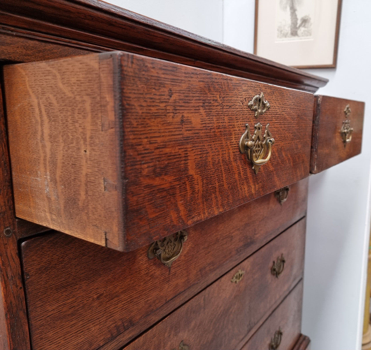 Early 19th Century English Oak chest on stand. It has been sourced in France and has plenty of storage space with eight drawers. In good original detailed condition.