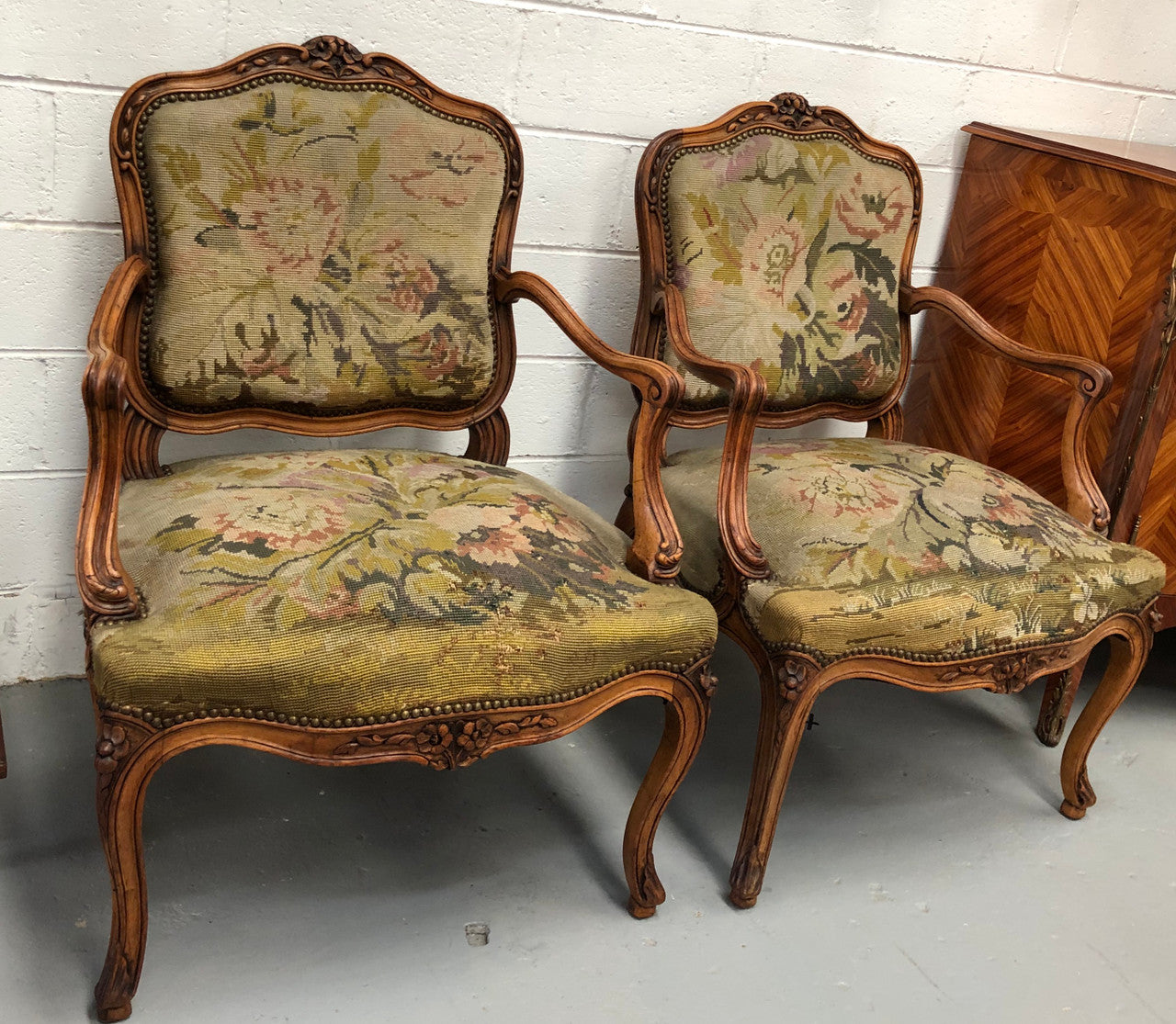 Pair of French Walnut Tapestry covered armchairs. They are in good original detailed condition. Slight wear and tear to fabric but still in good condition please view photos.