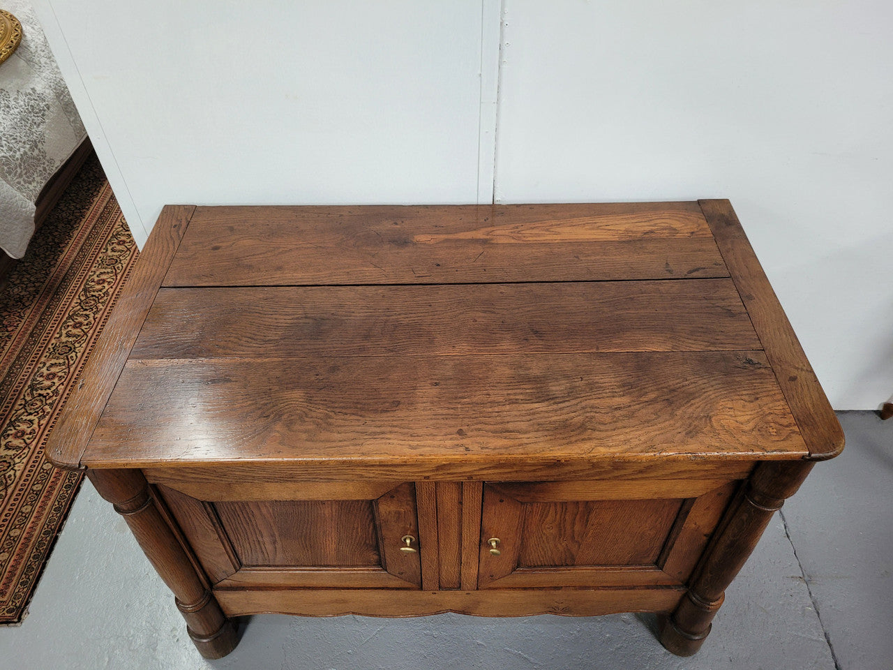 French 19th Century Oak dough bin buffet. The heavy solid top lifts upto reveal a half barrel compartment where traditionally flour and yeast were poured, mixed and proofed to grow into a nice dough.
Although originally intended for dough this would make an ideally TV cabinet with the two doors opening with plenty of storage.
