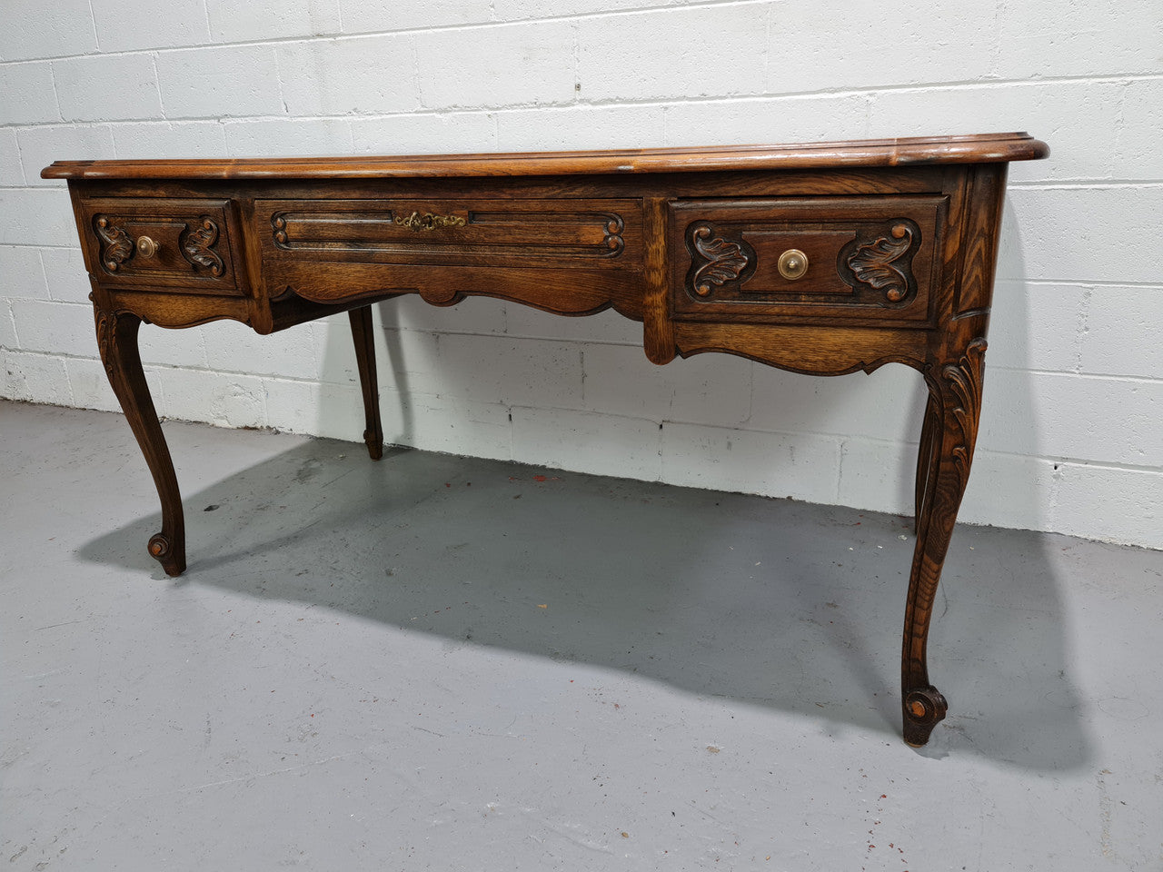 Attractive large Louis XV style Oak faux partners desk. Nicely carved details with three large functioning drawers, and three faux drawers at the back. In good original detailed condition.