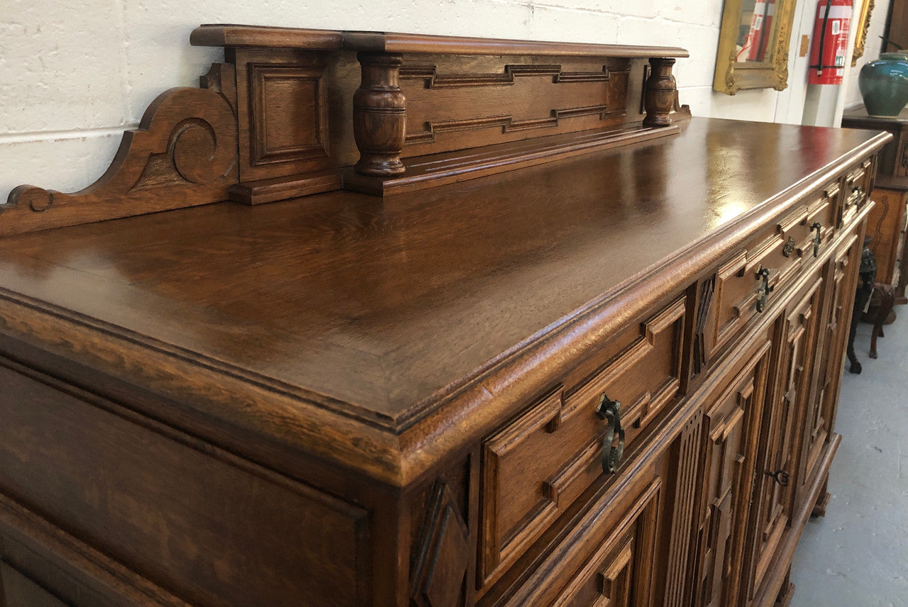 Beautiful carved French Oak four-door buffet with three drawers and lots of room for storage in good original detailed condition.