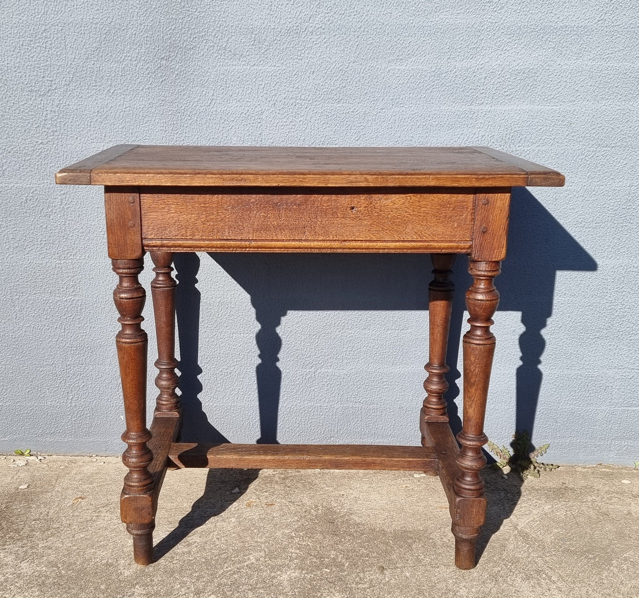 Lovely Oak Tudor style rope edge sideboard with leadlight centre door, three drawers and two solid cupboards. In good original condition.