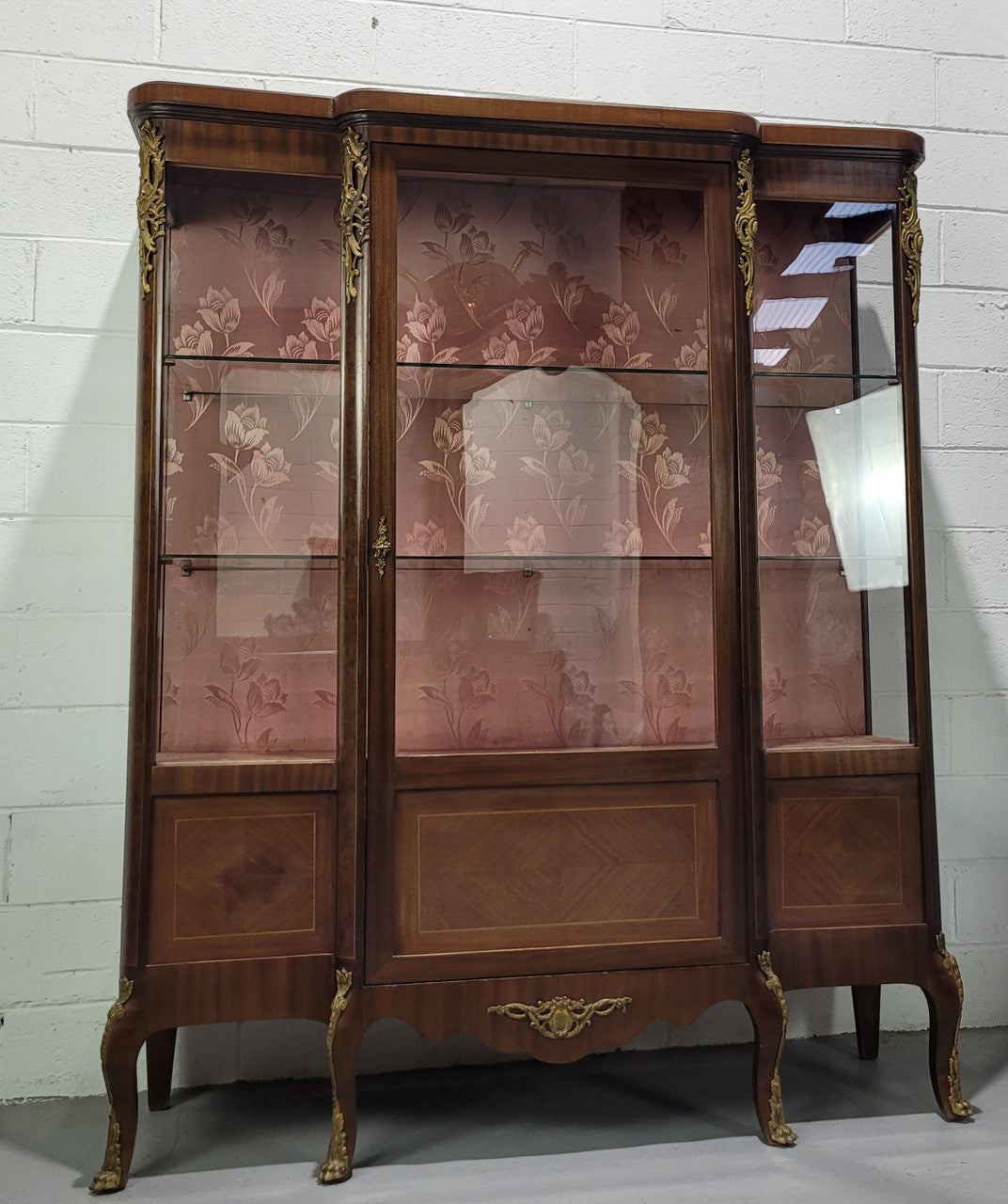 Beautiful French Louis XV style large walnut display cabinet with lovely ormolu mounts . There are two glass shelves and has its original dusky pink fabric in good condition.
